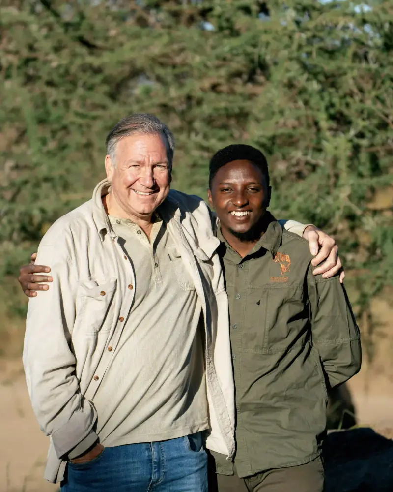 Guide and guest embracing warmly