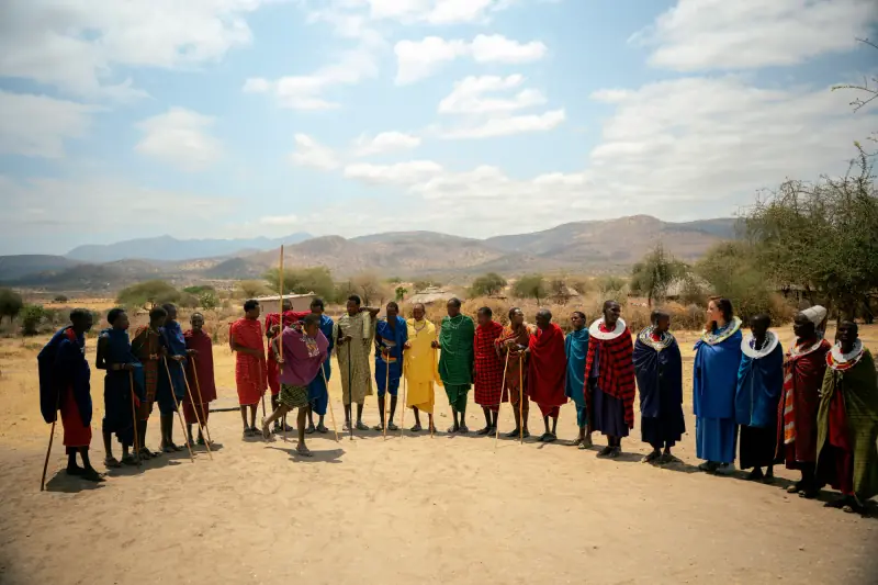 Maasai villagers gathered in a wide welcome circle