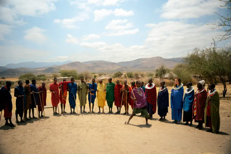 Maasai welcome dance circle with hills behind