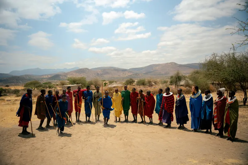 Maasai welcome circle spread across the village clearing