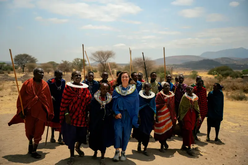 Maasai group walking together with the guest at the centre