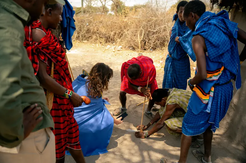Villagers crouching together as a demonstration begins