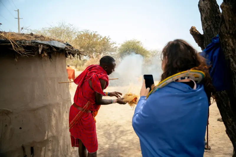 Guest filming a fire-starting demonstration on her phone