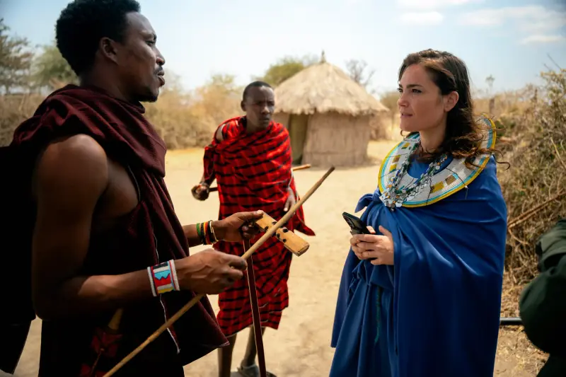 Warrior explaining a carved club to a guest