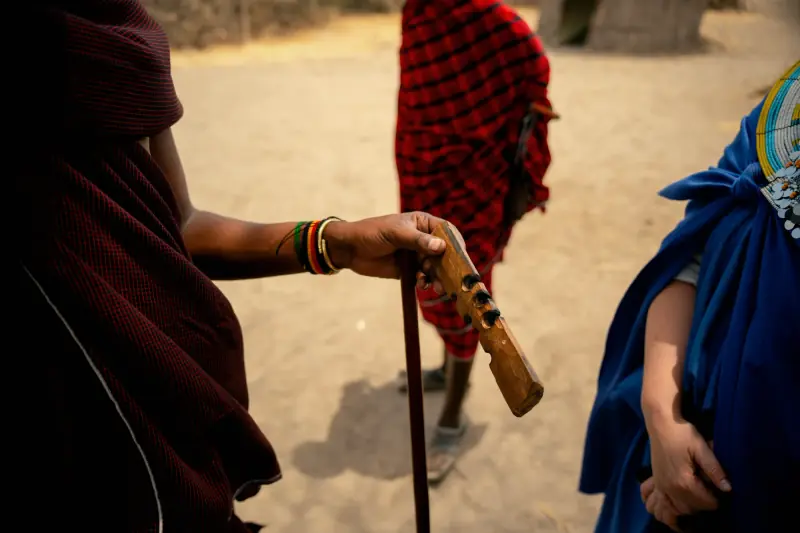 Close-up of a Maasai warrior's hands on a carved club