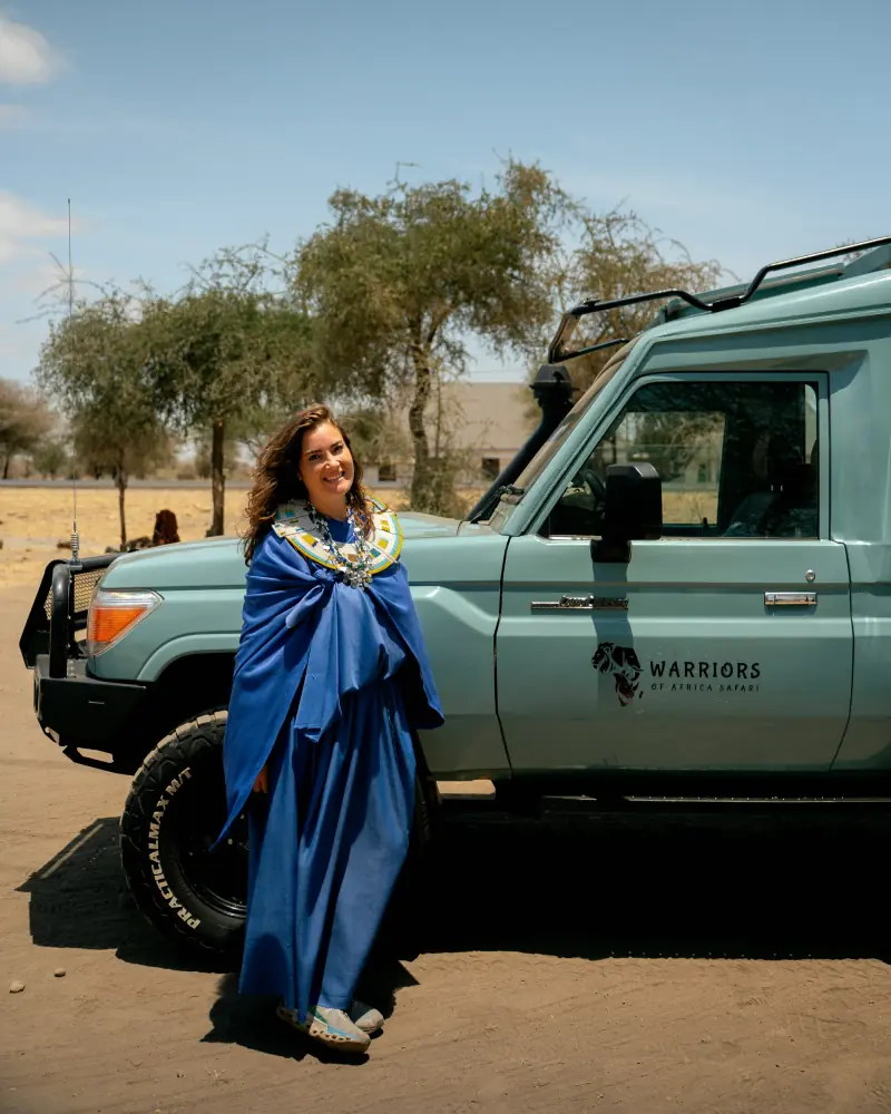 Guest beside a branded Warriors of Africa Land Cruiser