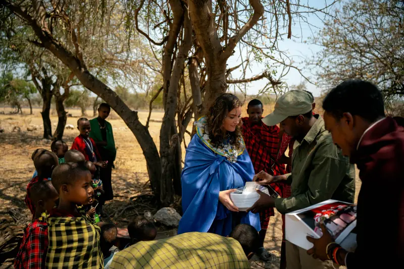 Serving a shared meal to village children