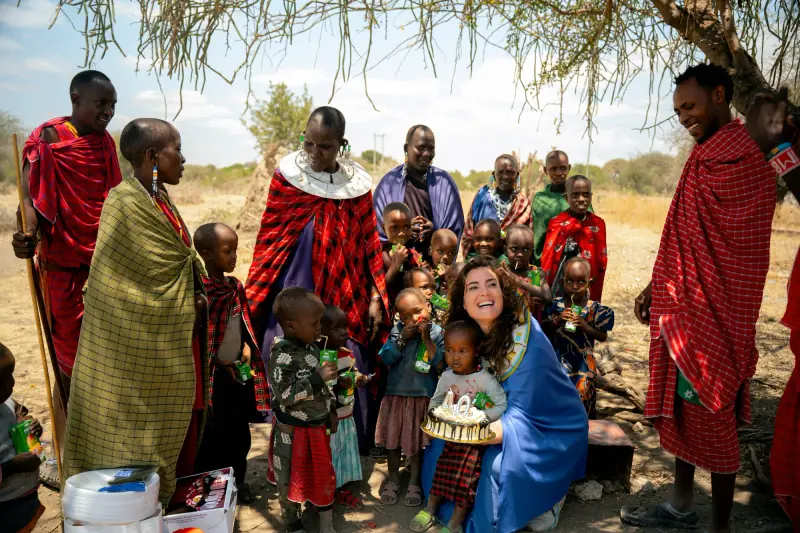 Village children gathered around a visiting guest