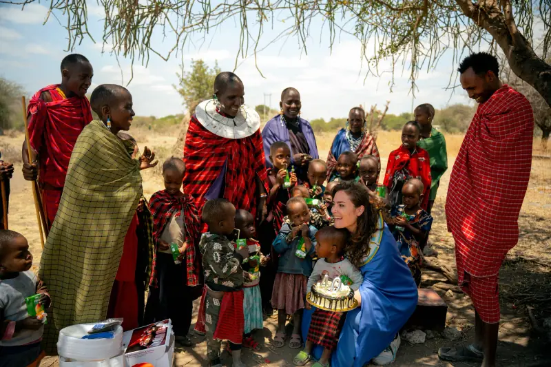 Guest surrounded by Maasai children and elders
