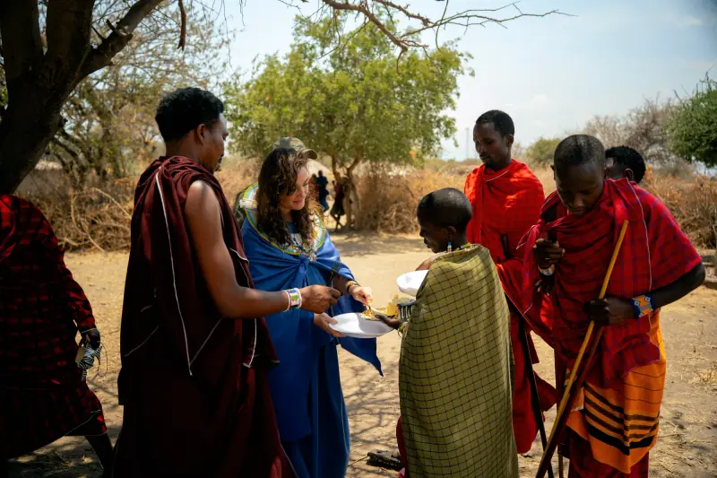 Handing out plates of food at the village