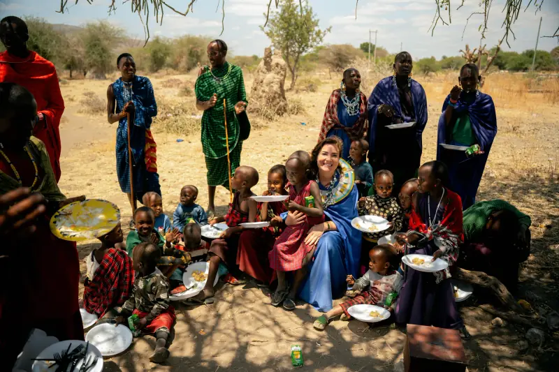 Sharing a meal with Maasai families under a tree