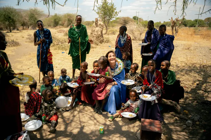 Seated with village children over shared plates