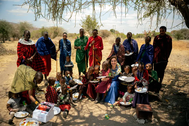 Village children eating together on the ground