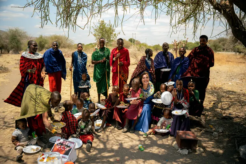 Guest seated among the children at the shared meal
