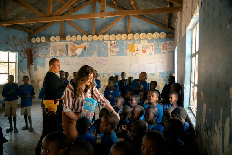 Greeting schoolchildren in a village classroom