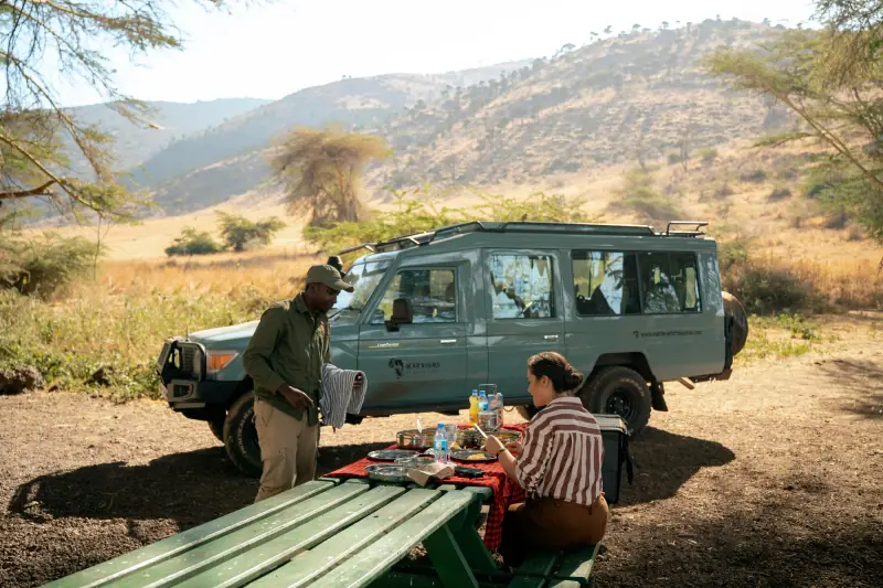 Bush picnic table set up beside the safari vehicle