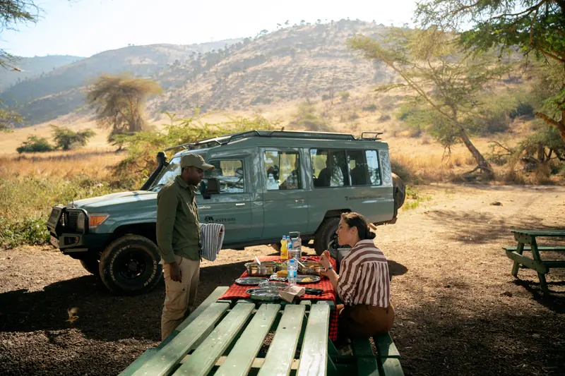 Guide setting out lunch at the crater picnic site