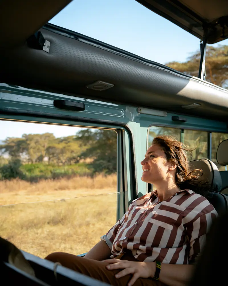 Guest resting against the vehicle window in low sun