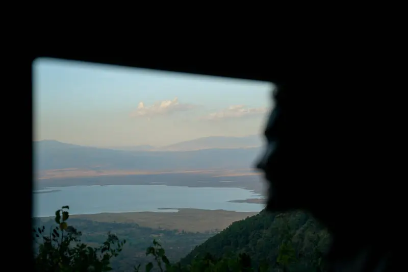 Crater rim and soda lake in the afternoon haze