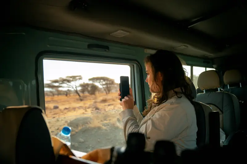 Guest photographing the plains from the vehicle