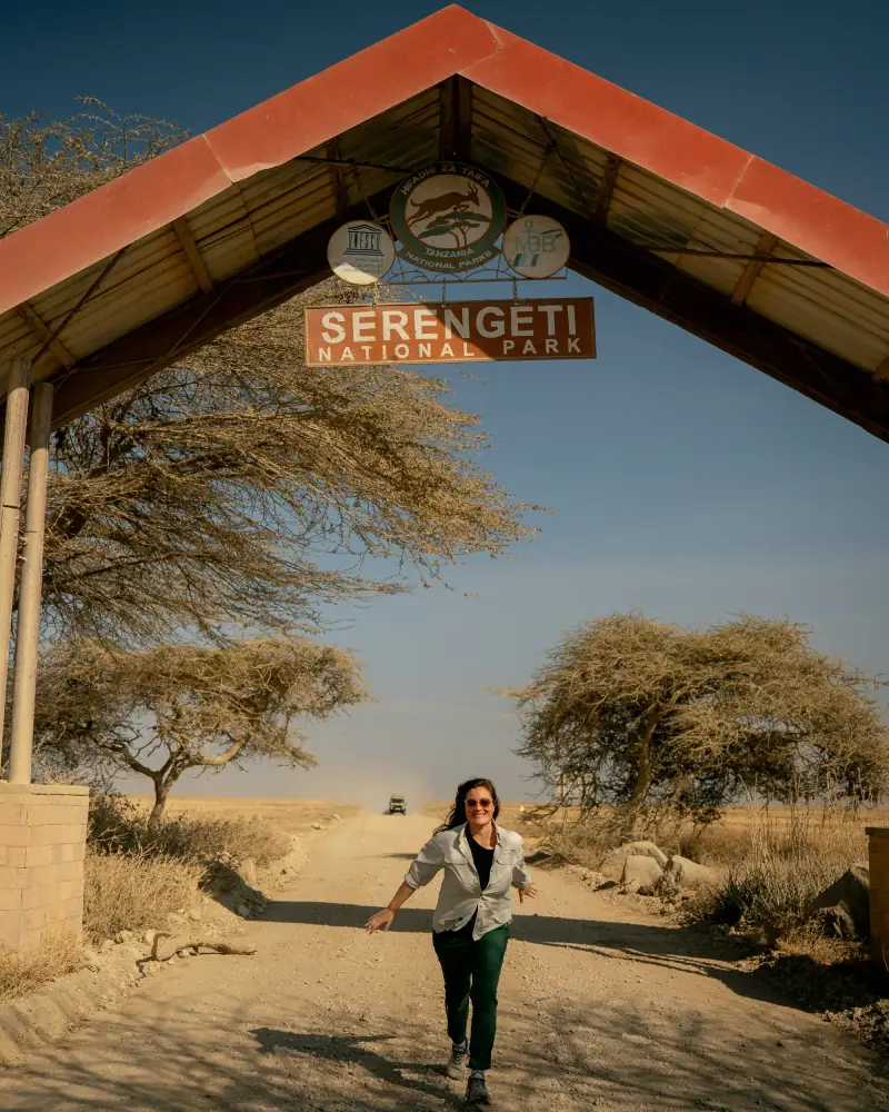Guest under the Serengeti National Park arch
