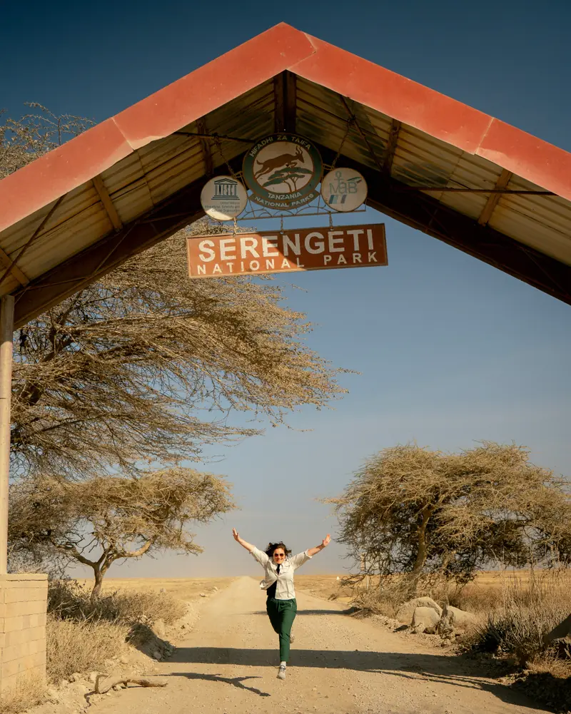 Waving from beneath the Serengeti entrance arch