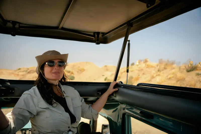 Guest in a safari hat riding with the roof open