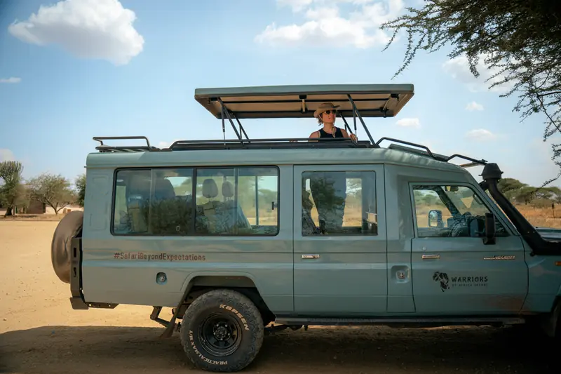 Safari vehicle on the track with the roof hatch up