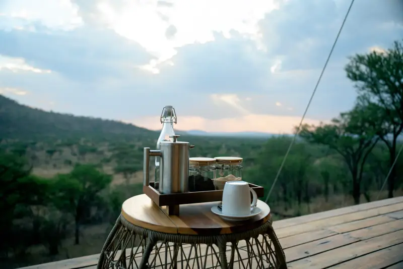Coffee tray waiting on the tented-camp deck at dawn