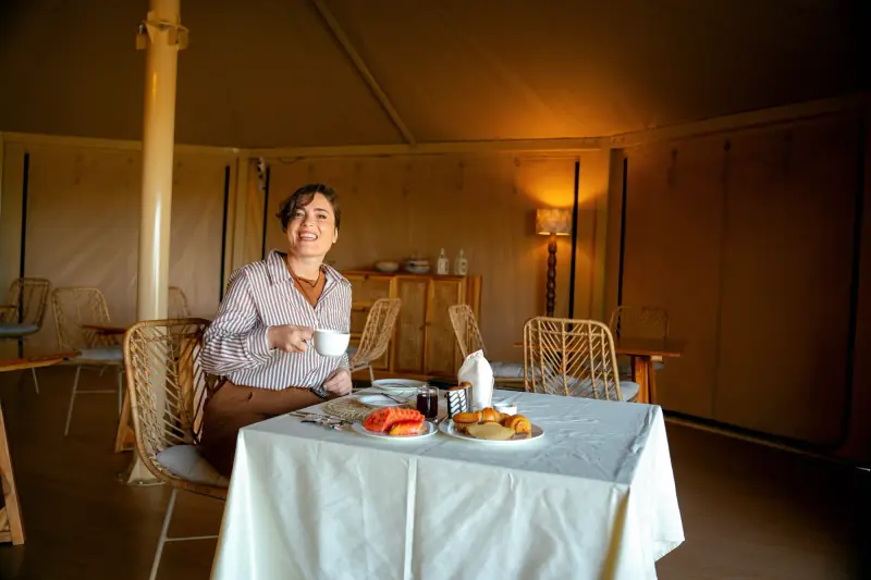 Guest at breakfast inside her tented suite