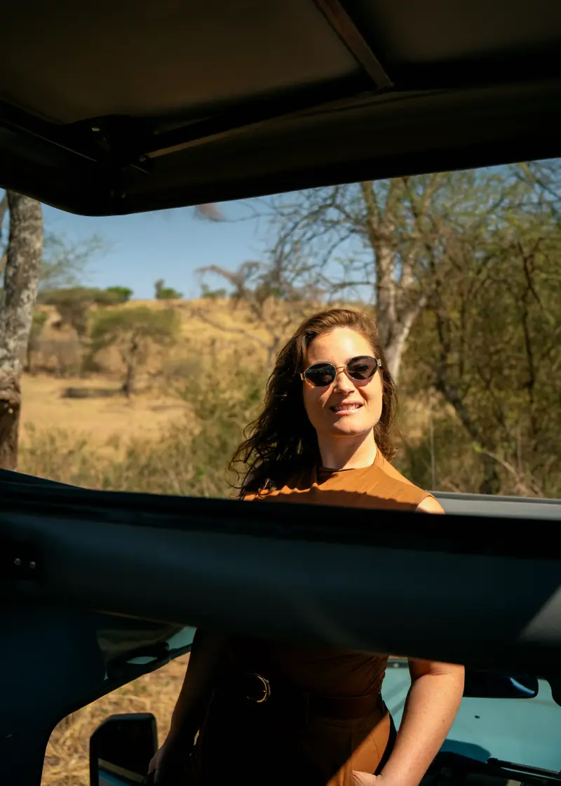 Guest smiling through the vehicle roof hatch