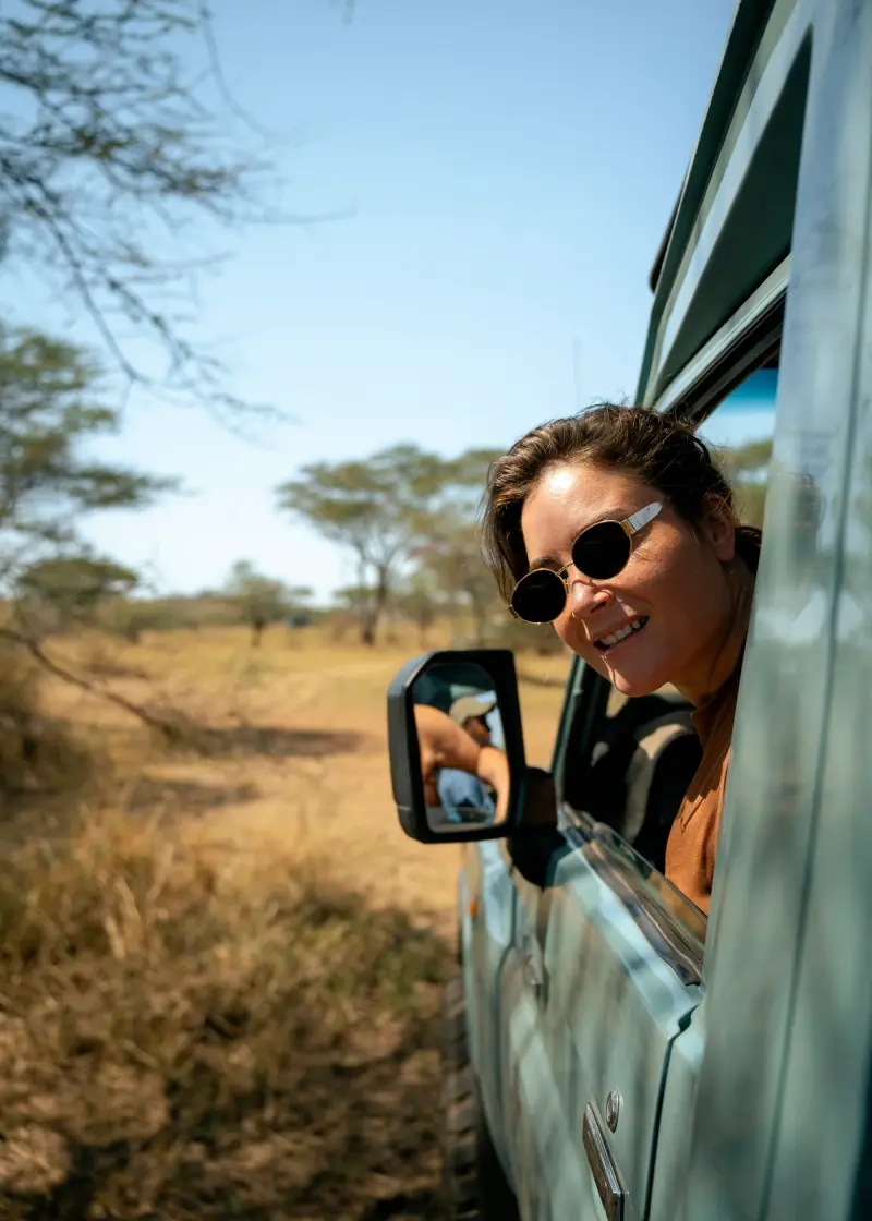 Guest leaning out of the window on a game drive