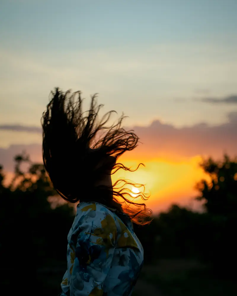 Hair thrown across the sunset