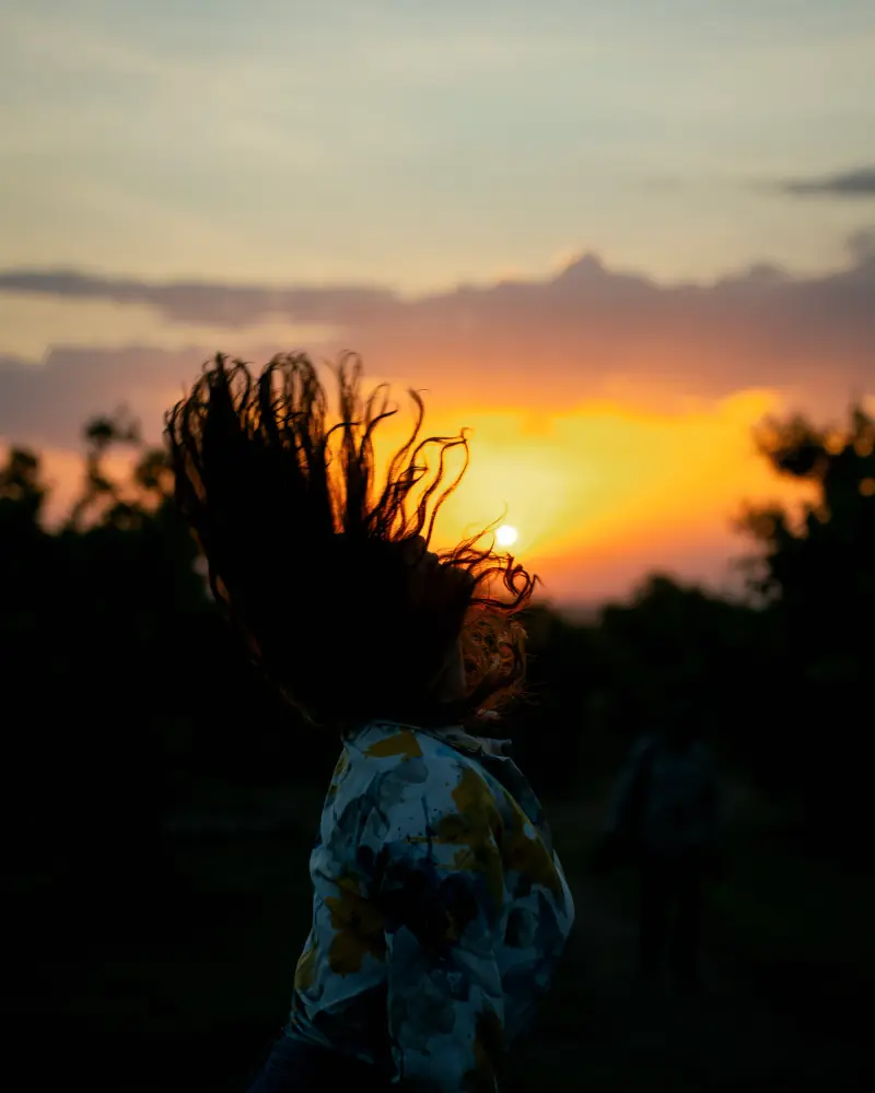 Sunset silhouette with hair thrown back
