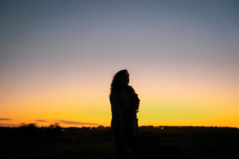 Guest standing against the pre-dawn horizon