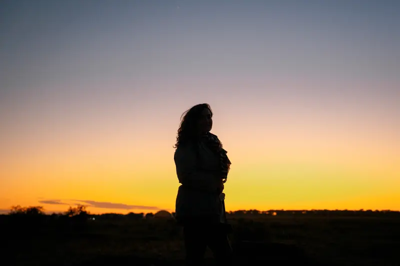 Standing against the pre-dawn horizon