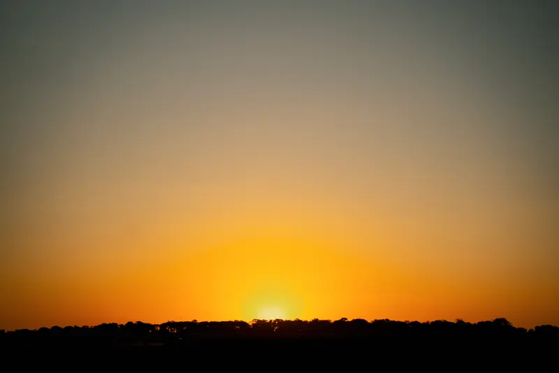 Sun clearing the horizon over the plains