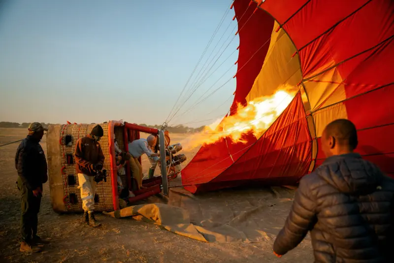 Crew firing the burner into the balloon envelope