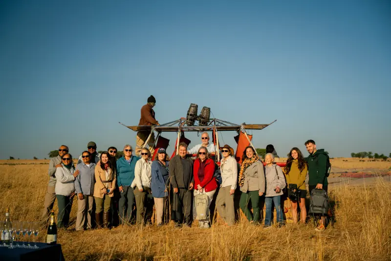 Group photo beside the balloon after landing