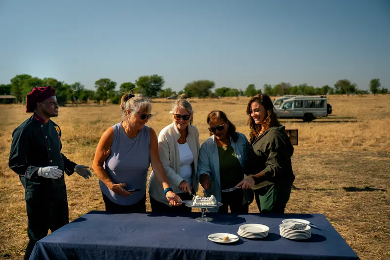 Crew and guests cutting the celebration cake