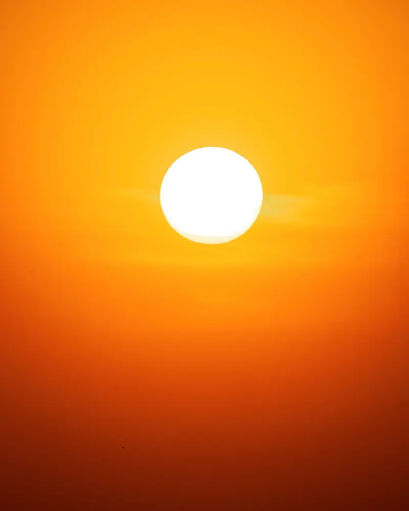 Full sun burning through an orange sky
